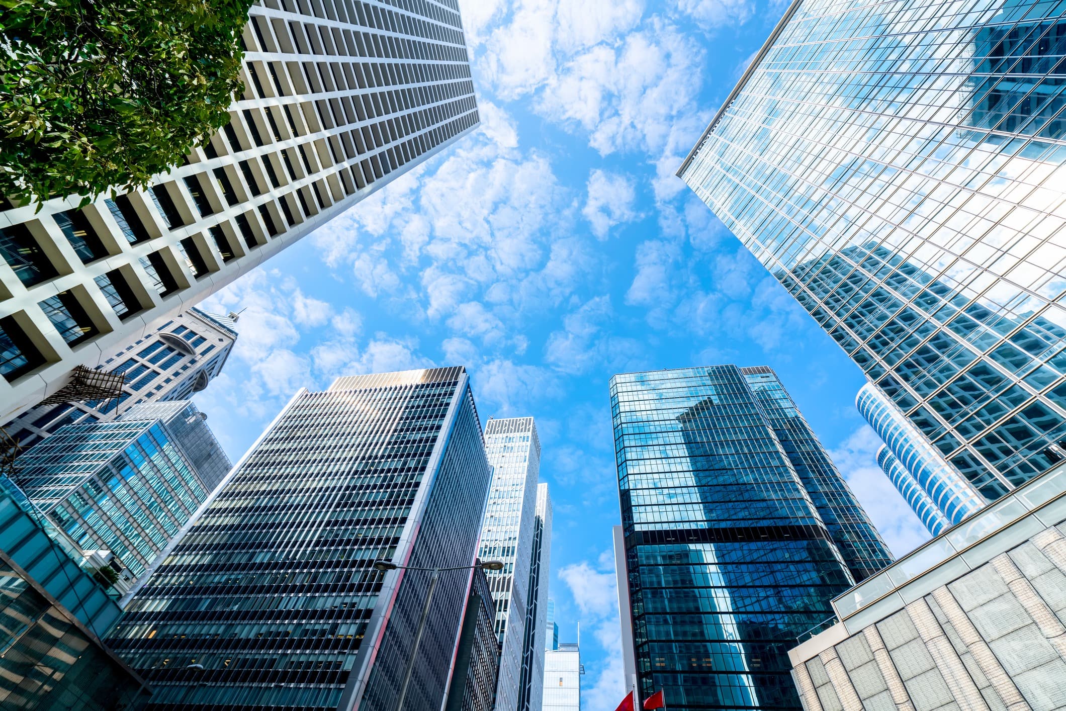 A looking up view of a series of high-rise financial services buildings.